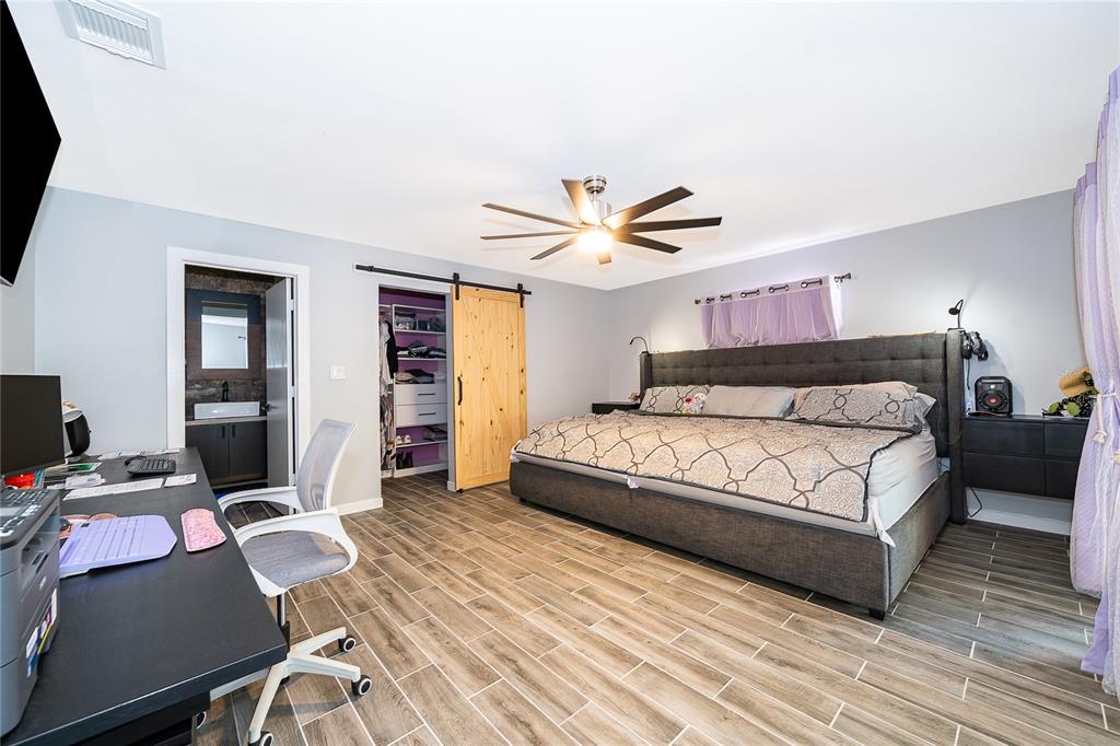 2350 Wekiva Ridge Road Apopka, FL 32712 - Photo 19 of 34 a bedroom with a bed and a desk