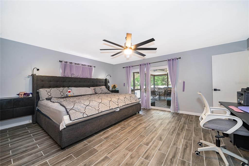 2350 Wekiva Ridge Road Apopka, FL 32712 - Photo 20 of 34 a bedroom with a bed and a table in it