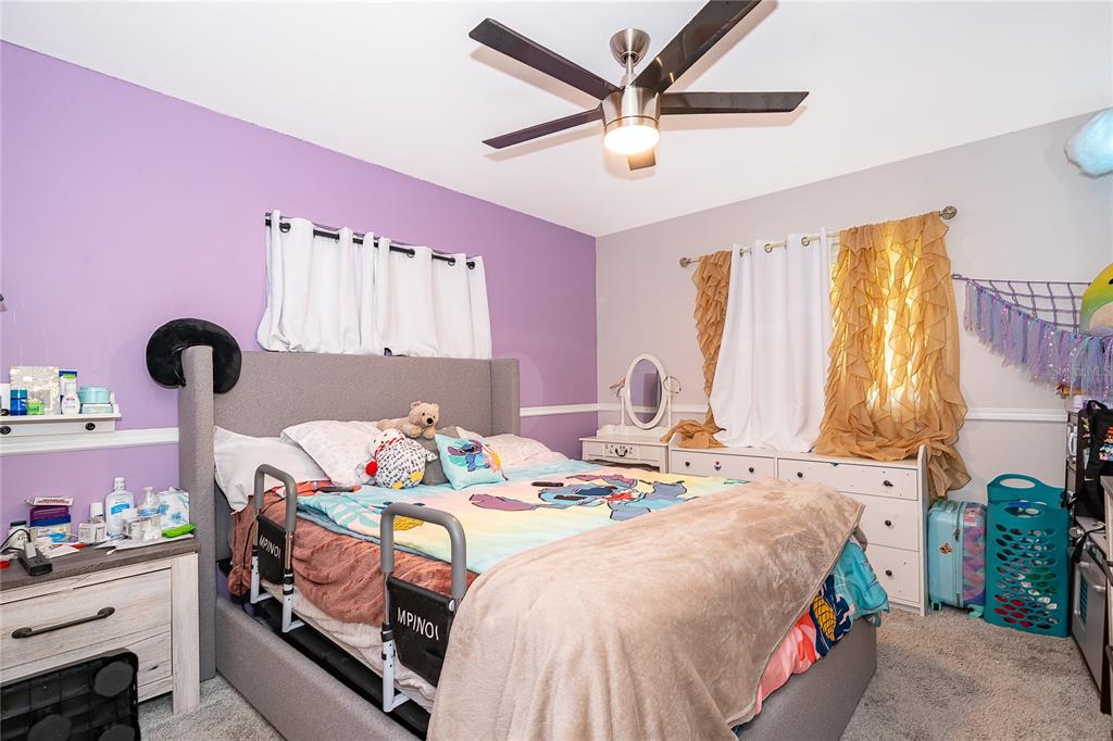 2350 Wekiva Ridge Road Apopka, FL 32712 - Photo 30 of 34 a bedroom with a bed and a chandelier