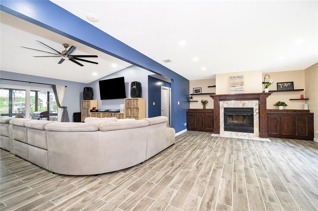2350 Wekiva Ridge Road Apopka, FL 32712 - Photo 5 of 34 a living room with furniture and a fireplace