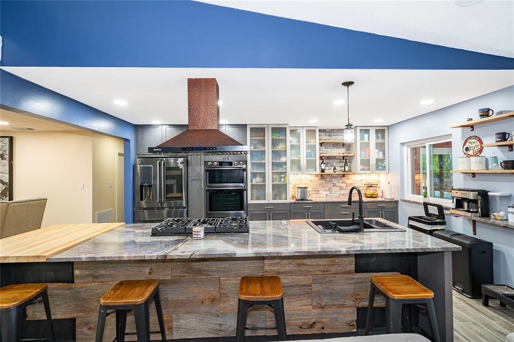 2350 Wekiva Ridge Road Apopka, FL 32712 - Photo 9 of 34 a kitchen with kitchen island granite countertop a table and chairs in it