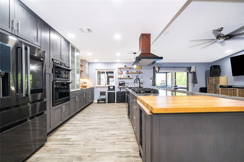 2350 Wekiva Ridge Road Apopka, FL 32712 - Photo 10 of 34 a large kitchen with stainless steel appliances granite countertop a large counter top a stove and a sink