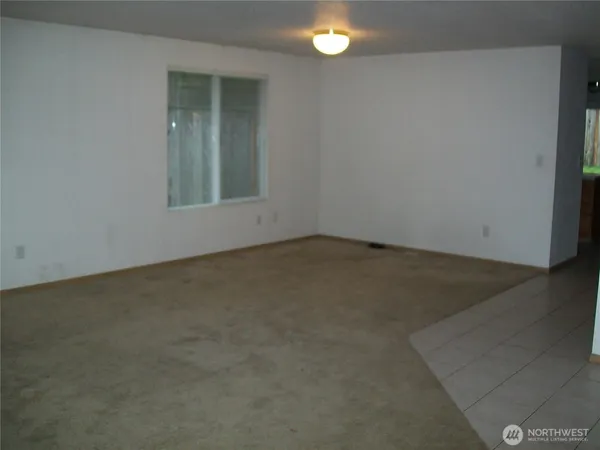 an empty room with a empty space and window