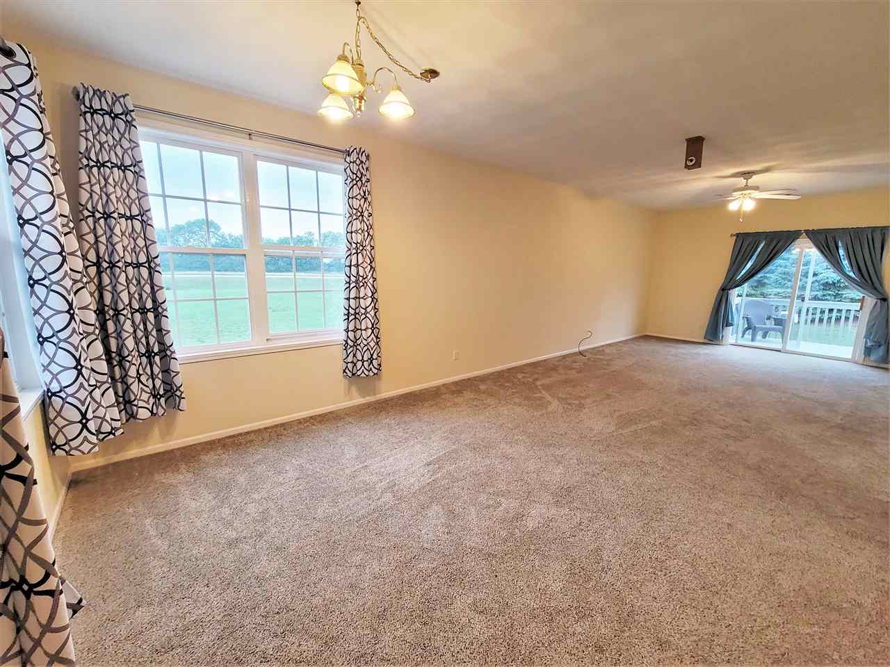 10138 B Monarch Road Roscoe, IL 61073 - Photo 2 of 24 an empty room with windows and outdoor view