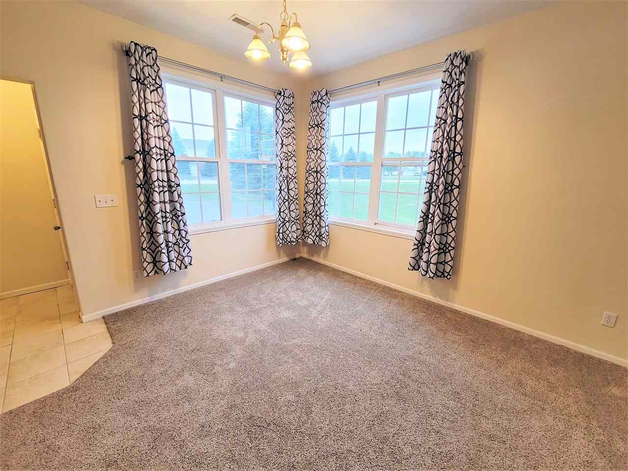 10138 B Monarch Road Roscoe, IL 61073 - Photo 3 of 24 a view of an empty room with a window