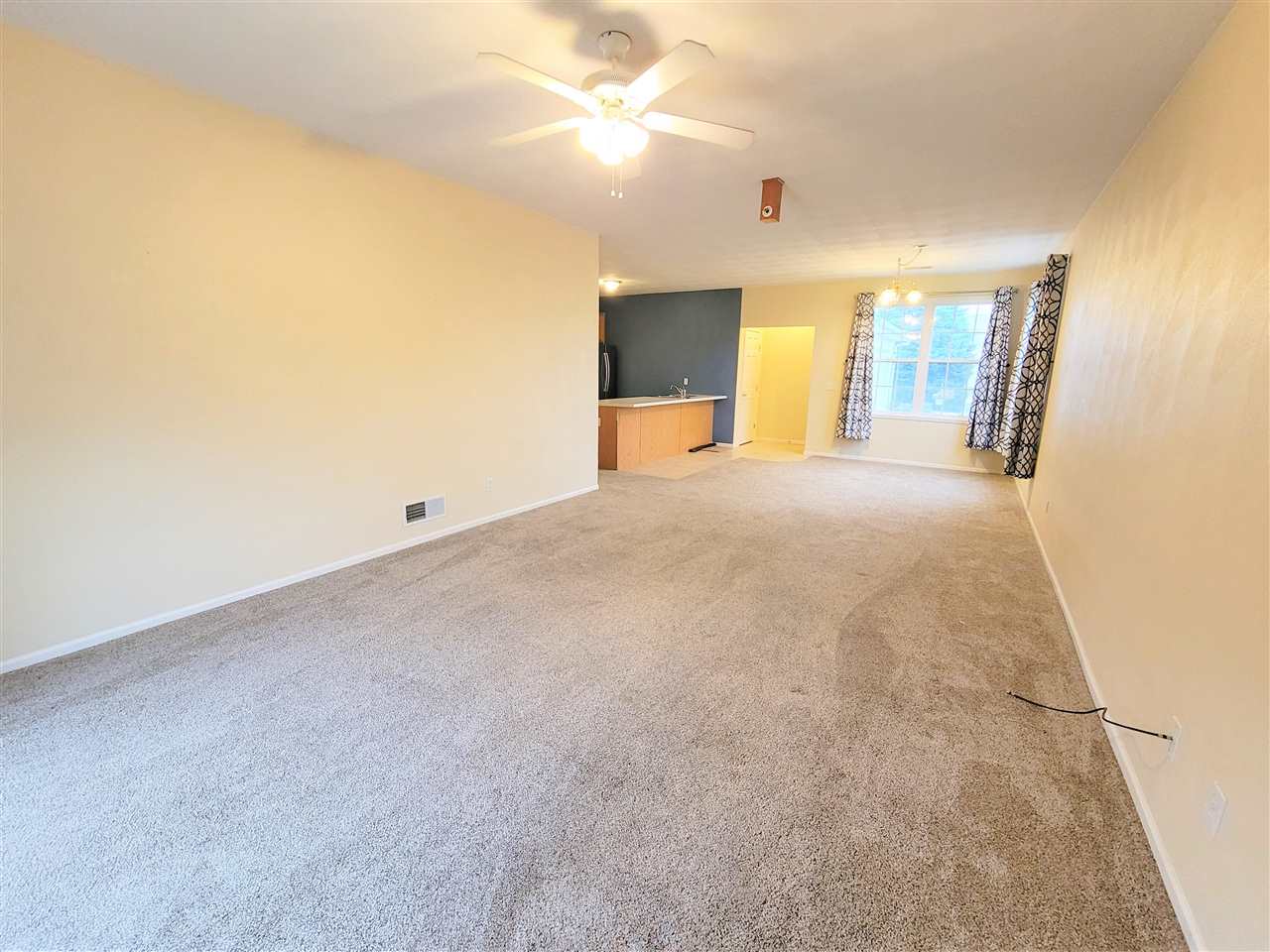 10138 B Monarch Road Roscoe, IL 61073 - Photo 7 of 24 a view of an empty room with window and a kitchen