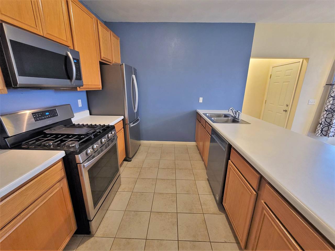 10138 B Monarch Road Roscoe, IL 61073 - Photo 9 of 24 a kitchen with a sink a stove top oven a refrigerator and a stove