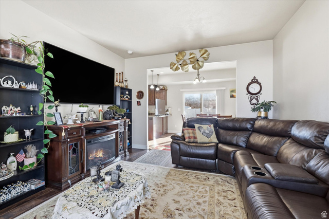 1084 South 740 East Logan, UT 84321 - Photo 3 of 23 Living room with suspended lighting, wood finished floors, and a glass covered fireplace