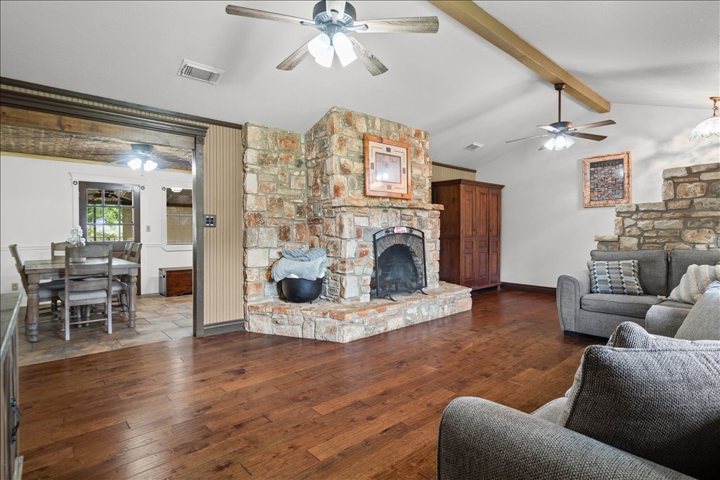2421 Post Oak Road Webberville, TX 78653 - Photo 6 of 36 Check out this stone fireplace! It creates a beautiful natural division between the living room and the kitchen area.