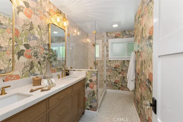 a bathroom with a double vanity sink mirror and shower