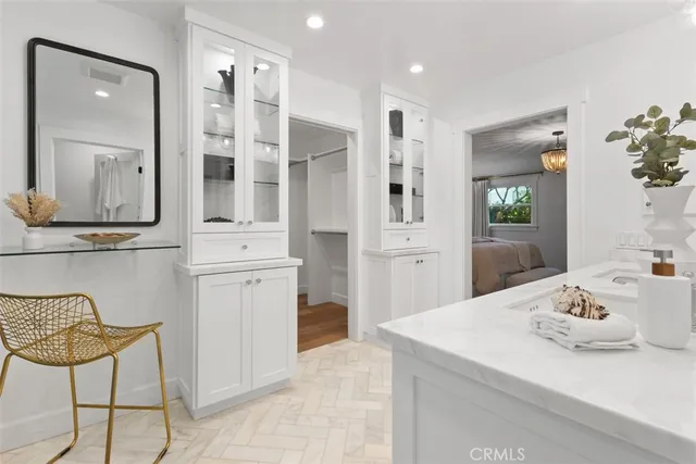 a kitchen with a sink cabinets and wooden floor