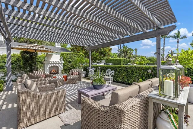 a view of a patio with couches chairs dining table and chairs with wooden floor