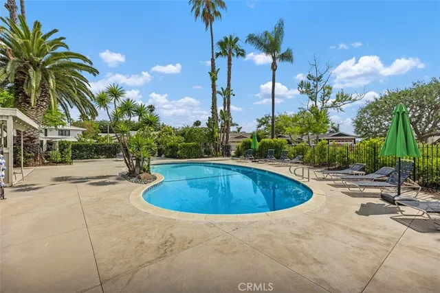 a swimming pool with outdoor seating and yard