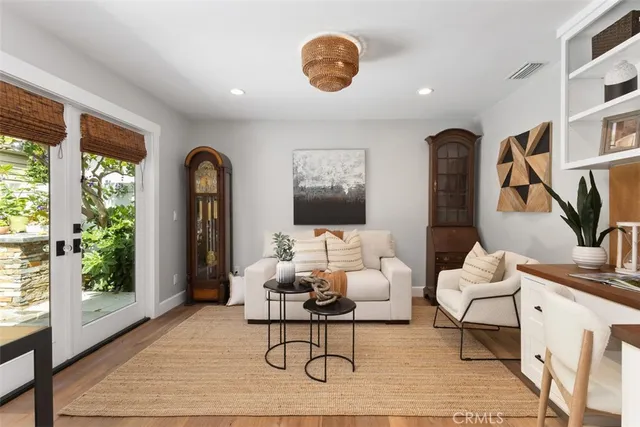 a living room with furniture potted plant and a large window