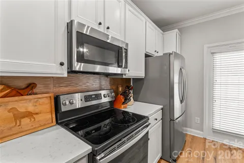a kitchen with stainless steel appliances and cabinets