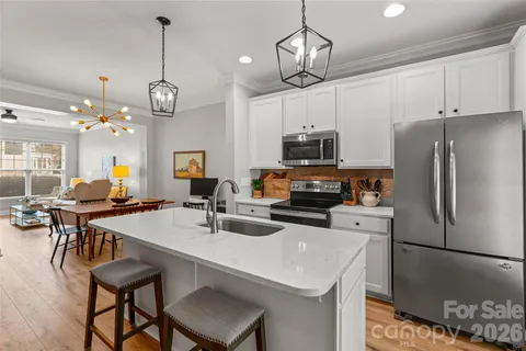 a kitchen with refrigerator cabinets and dining table