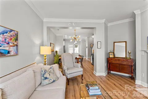 a living room with furniture and a chandelier