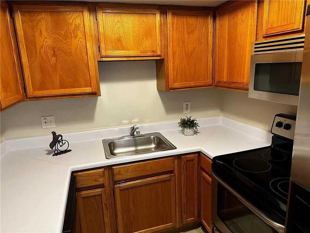 105 South Riverside Drive, Unit 303 Pompano Beach, FL 33062 - Photo 19 of 36 a kitchen with appliances cabinets and a sink