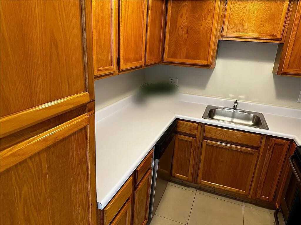 105 South Riverside Drive, Unit 303 Pompano Beach, FL 33062 - Photo 20 of 36 a kitchen with a sink and cabinets