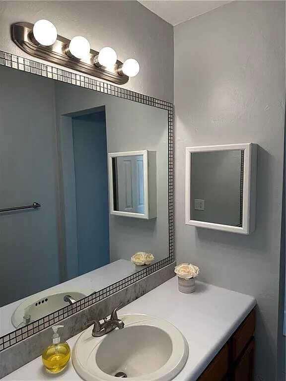 105 South Riverside Drive, Unit 303 Pompano Beach, FL 33062 - Photo 21 of 36 a bathroom with a sink and a mirror