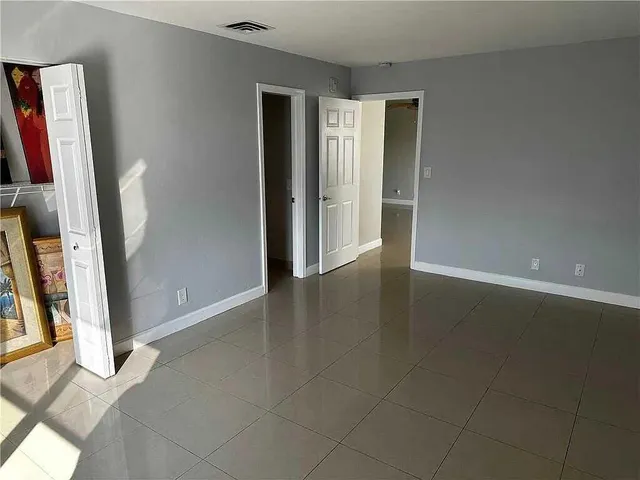 a bedroom with bed and window