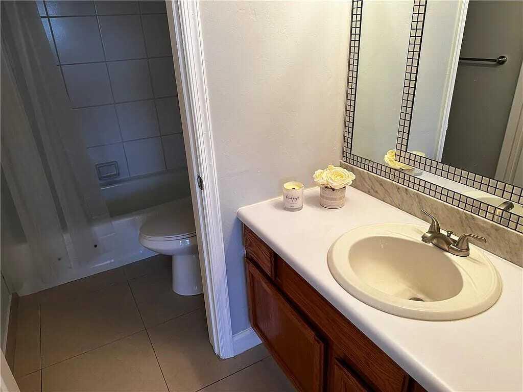 105 South Riverside Drive, Unit 303 Pompano Beach, FL 33062 - Photo 27 of 36 a bathroom with a sink and a mirror