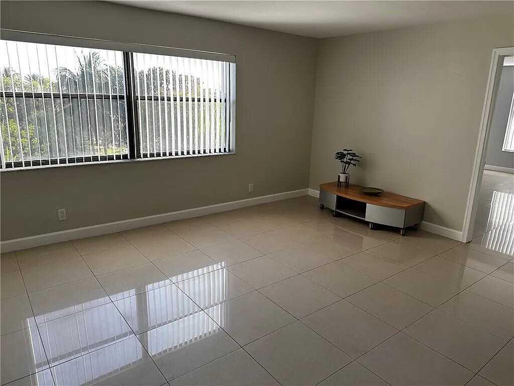 105 South Riverside Drive, Unit 303 Pompano Beach, FL 33062 - Photo 32 of 36 a room with a chair and a window