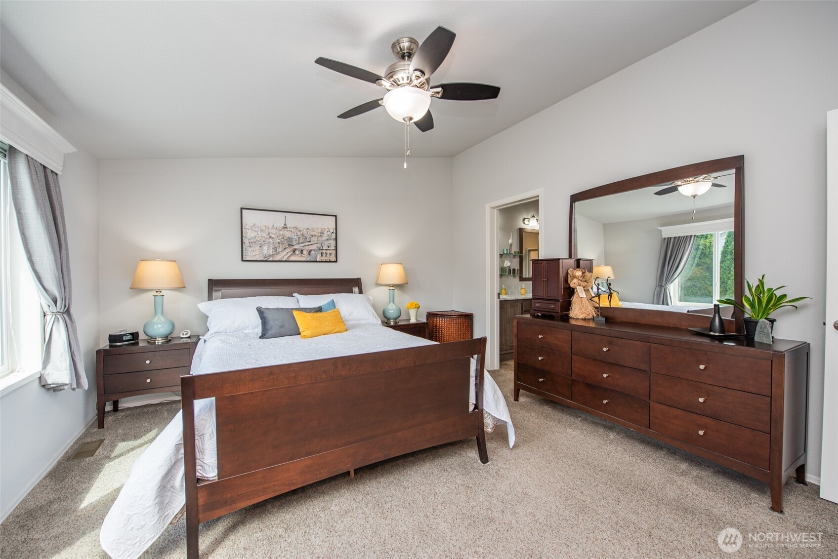 720 West Heritage Loop Sequim, WA 98382 - Photo 20 of 35 a bedroom with a bed and a dresser in it