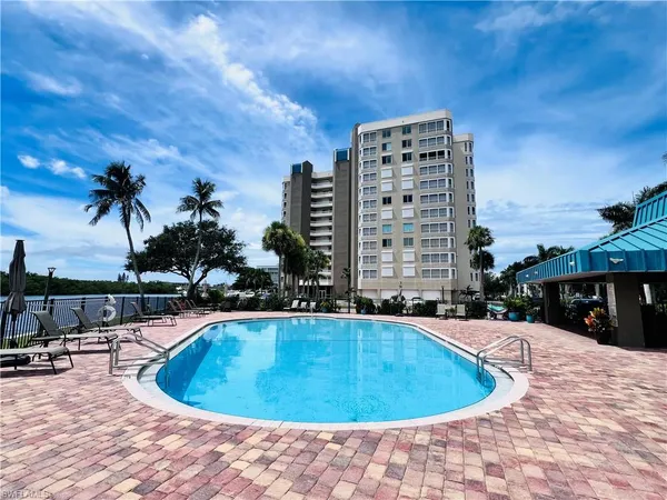 a view of a swimming pool with outdoor seating