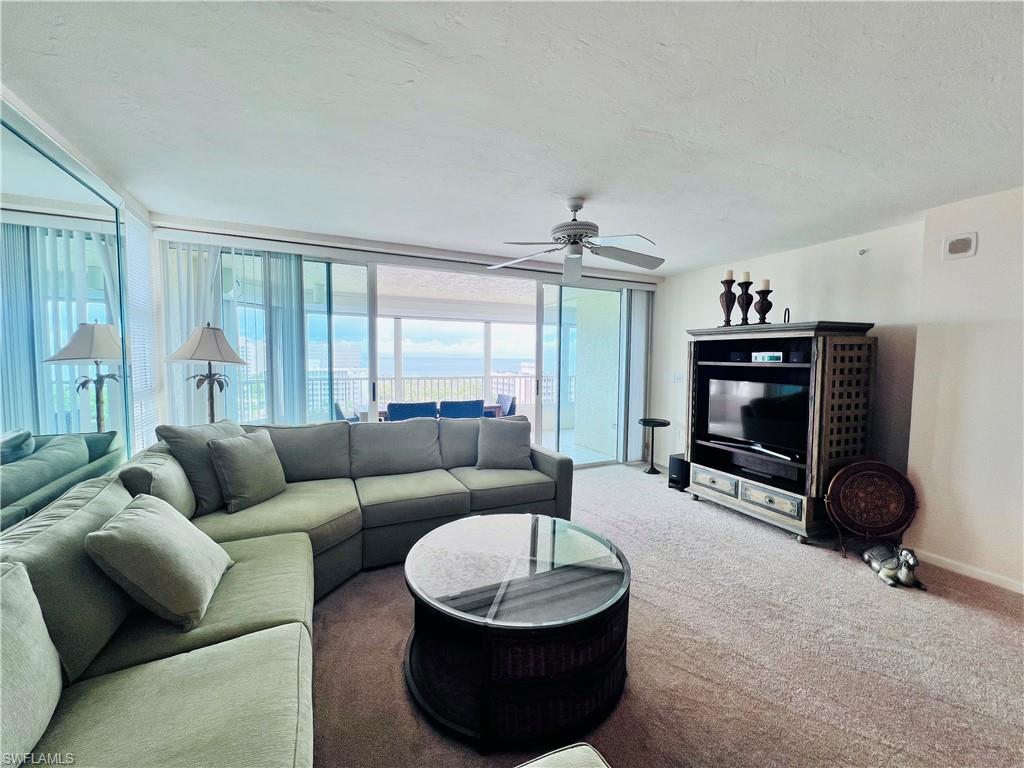 25 Bluebill Avenue, Unit 1002 Naples, FL 34108 - Photo 11 of 34 a living room with furniture a air conditioner vent and a window