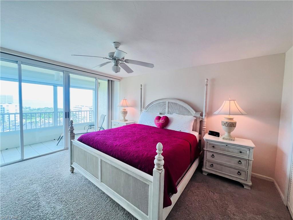 25 Bluebill Avenue, Unit 1002 Naples, FL 34108 - Photo 14 of 34 a bedroom with a bed and a large window