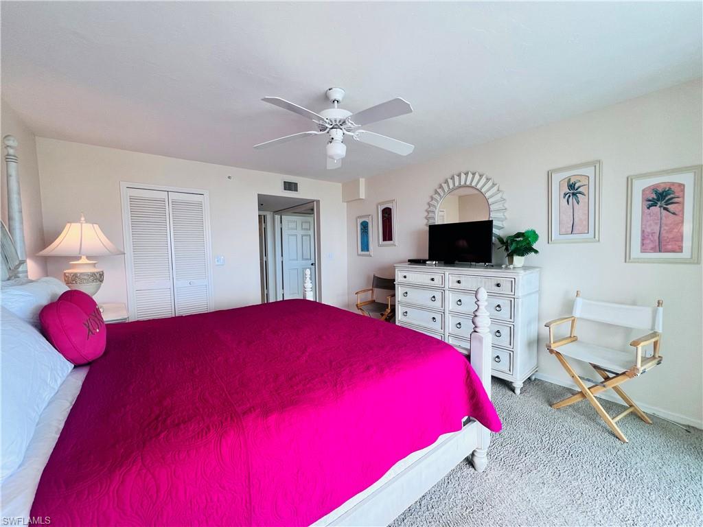 25 Bluebill Avenue, Unit 1002 Naples, FL 34108 - Photo 16 of 34 a bedroom with a bed and a flat screen tv