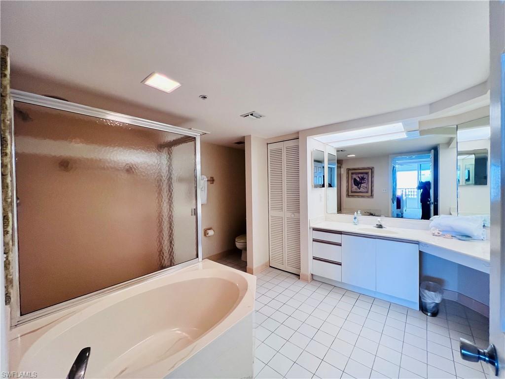 25 Bluebill Avenue, Unit 1002 Naples, FL 34108 - Photo 17 of 34 a large spacious bathroom with a tub shower and sink