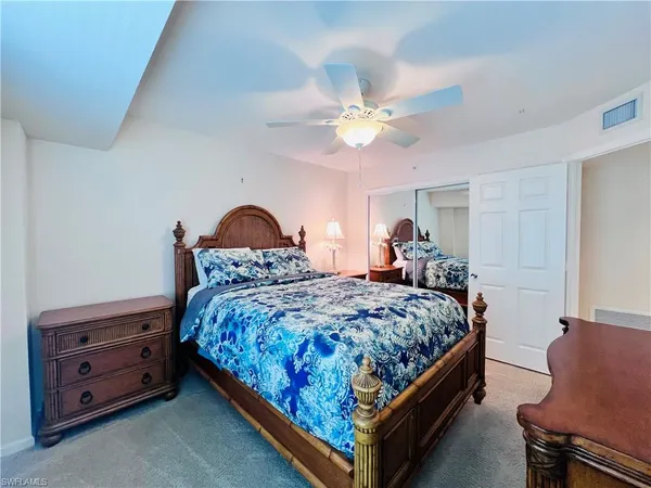 a bed room with a bed and a chandelier