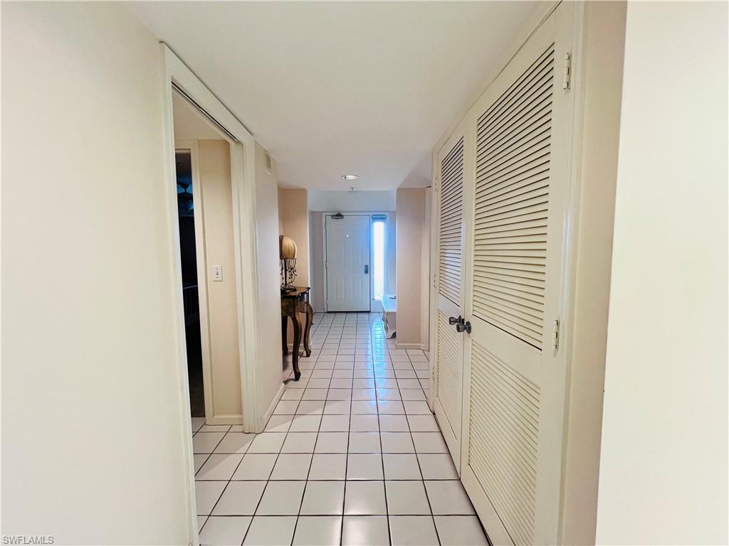 25 Bluebill Avenue, Unit 1002 Naples, FL 34108 - Photo 27 of 34 a view of a hallway with wooden floor and staircase