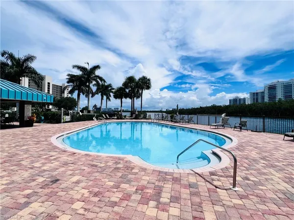 a view of a swimming pool with an outdoor seating and a yard
