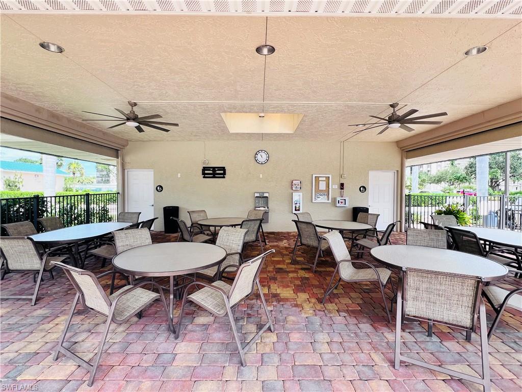 25 Bluebill Avenue, Unit 1002 Naples, FL 34108 - Photo 31 of 34 a view of a dining room with furniture window and wooden floor