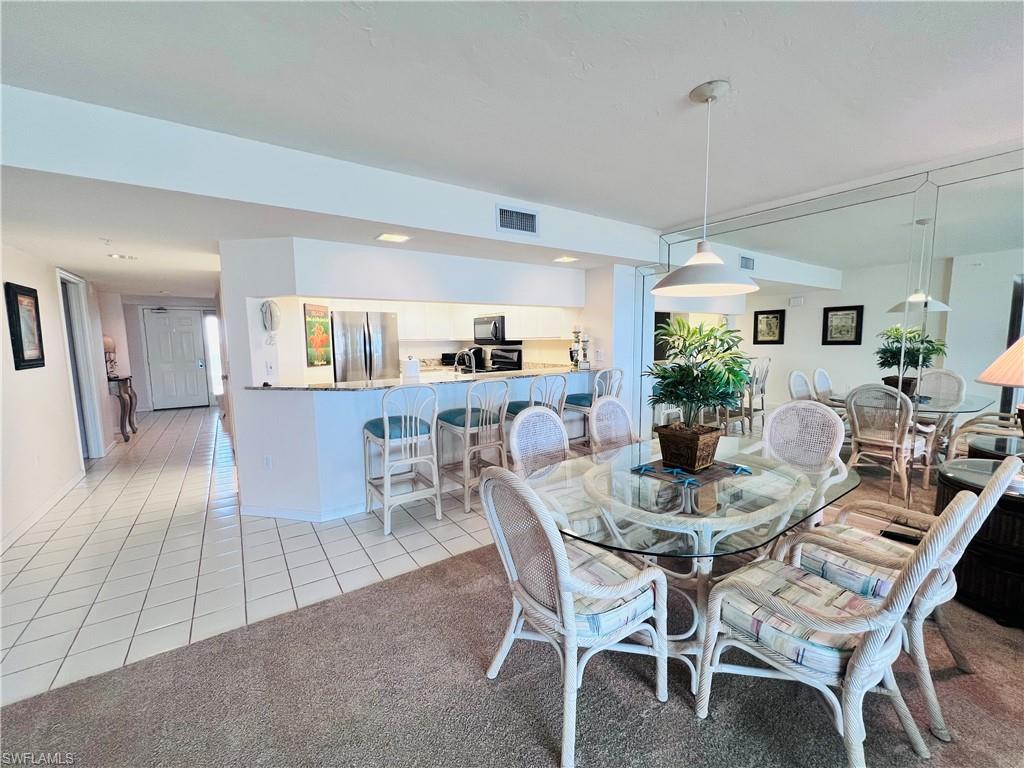 25 Bluebill Avenue, Unit 1002 Naples, FL 34108 - Photo 7 of 34 a view of a dining room with furniture