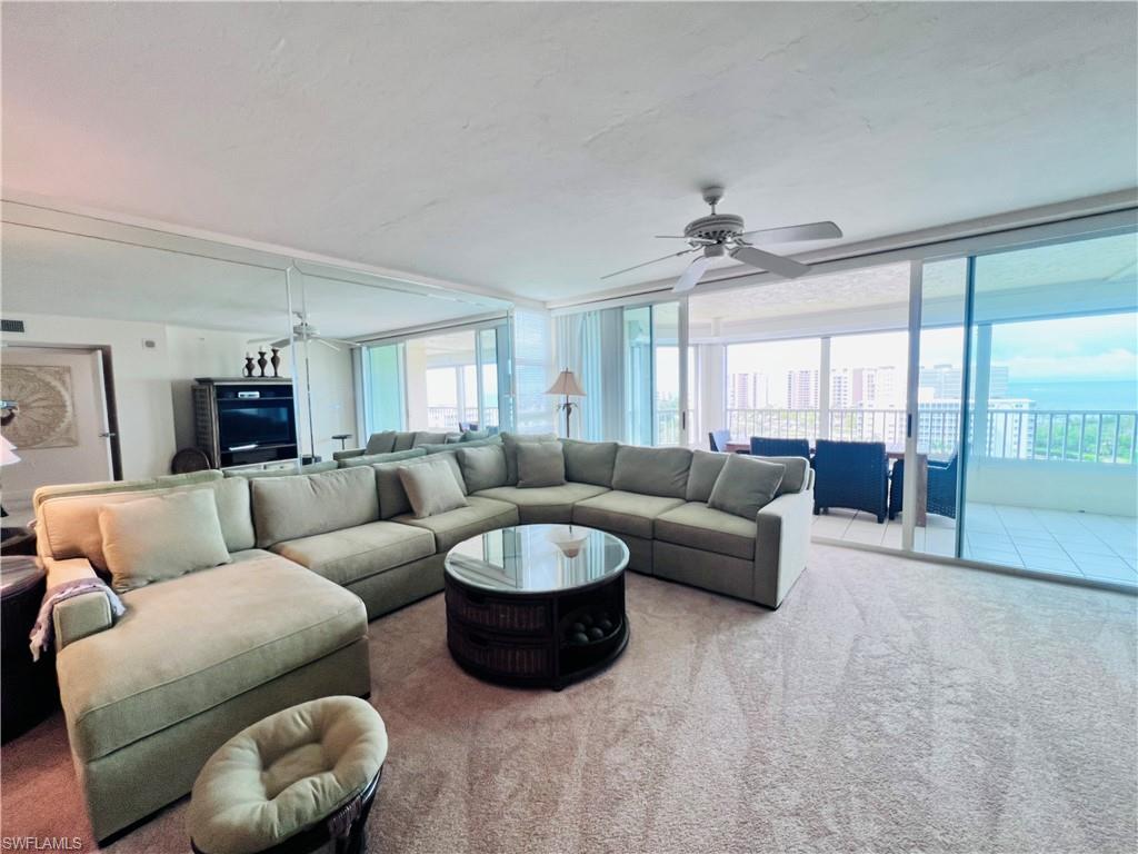 25 Bluebill Avenue, Unit 1002 Naples, FL 34108 - Photo 10 of 34 a living room with furniture and a large window