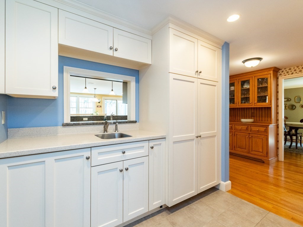 16 Fuller Brook Road Wellesley, MA 02482 - Photo 13 of 36 a kitchen with white cabinets and white appliances