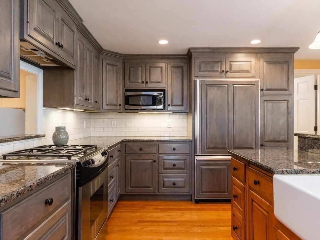 16 Fuller Brook Road Wellesley, MA 02482 - Photo 16 of 36 a kitchen with stainless steel appliances granite countertop a stove a sink dishwasher and a refrigerator