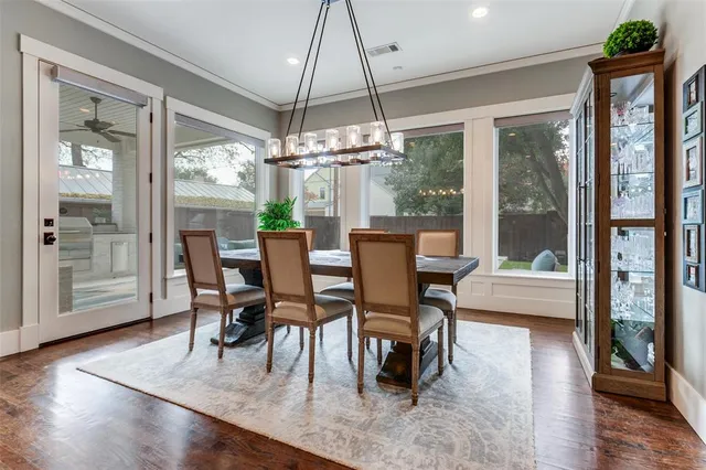 a dining room with furniture a chandelier and wooden floor