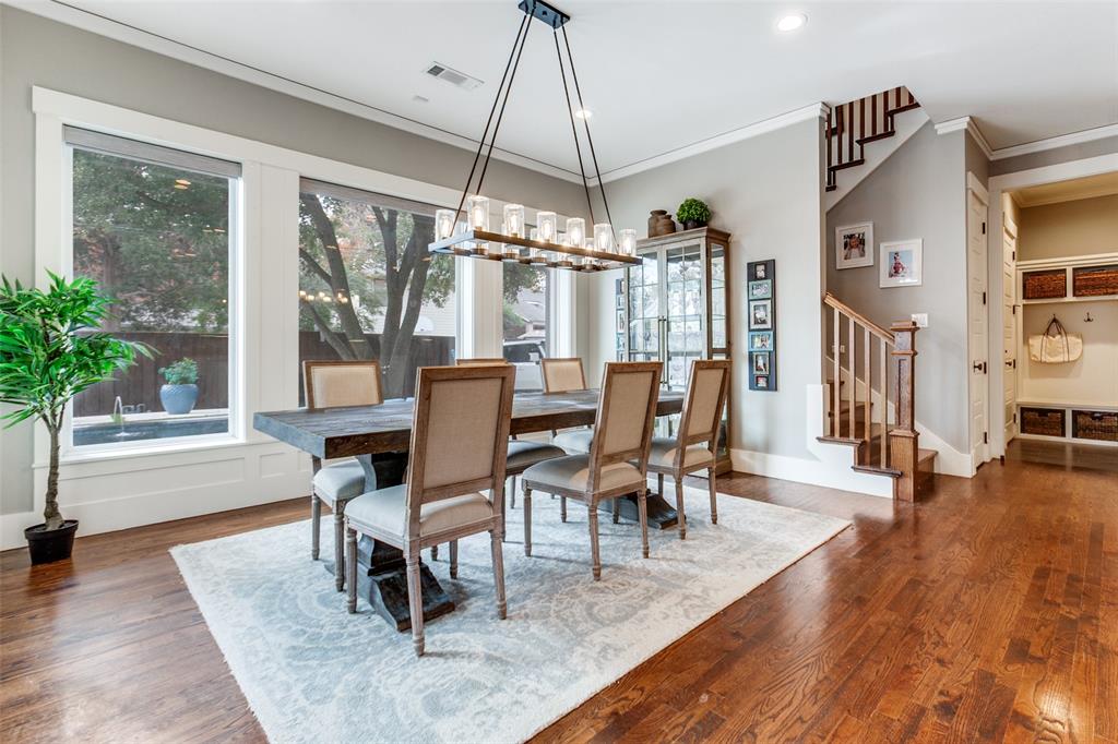 413 Ridge Crest Drive Richardson, TX 75080 - Photo 13 of 34 a dining room with wooden floor a chandelier a glass table and chairs