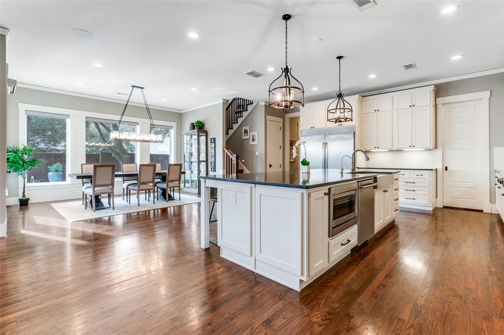 413 Ridge Crest Drive Richardson, TX 75080 - Photo 14 of 34 a kitchen with stainless steel appliances granite countertop wooden floors and white cabinets