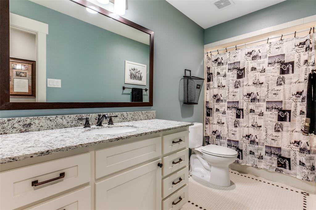 413 Ridge Crest Drive Richardson, TX 75080 - Photo 20 of 34 a bathroom with a granite countertop sink a toilet and a mirror