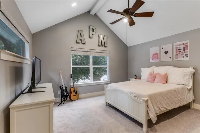 a bedroom with a bed and a tv on the dresser