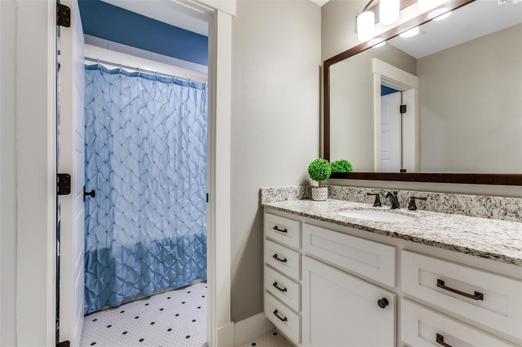 413 Ridge Crest Drive Richardson, TX 75080 - Photo 23 of 34 a bathroom with a granite countertop sink and a mirror