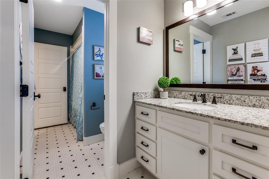 413 Ridge Crest Drive Richardson, TX 75080 - Photo 24 of 34 a bathroom with a sink and a mirror