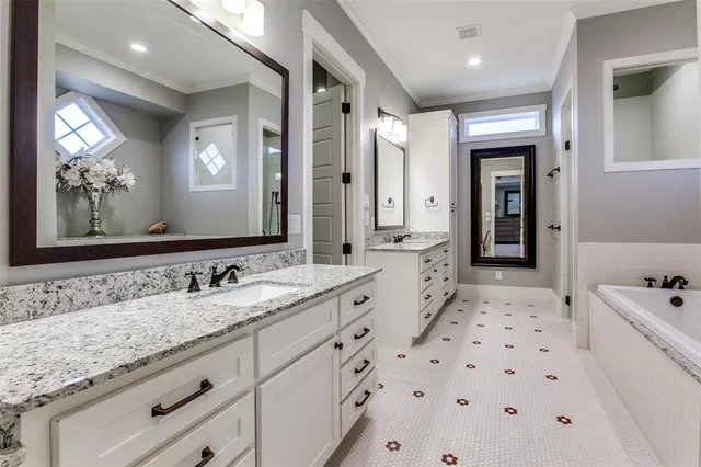 a spacious bathroom with a sink double vanity granite and a mirror