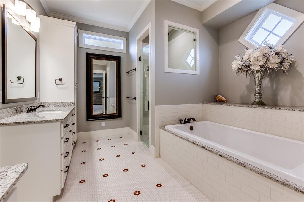 413 Ridge Crest Drive Richardson, TX 75080 - Photo 28 of 34 a bathroom with a bathtub sink and mirror